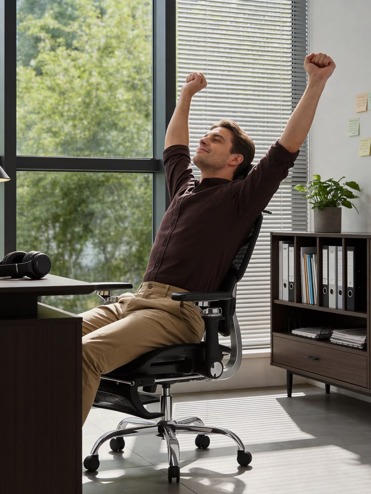 A person reaching upward in a gentle stretch beside a home desk